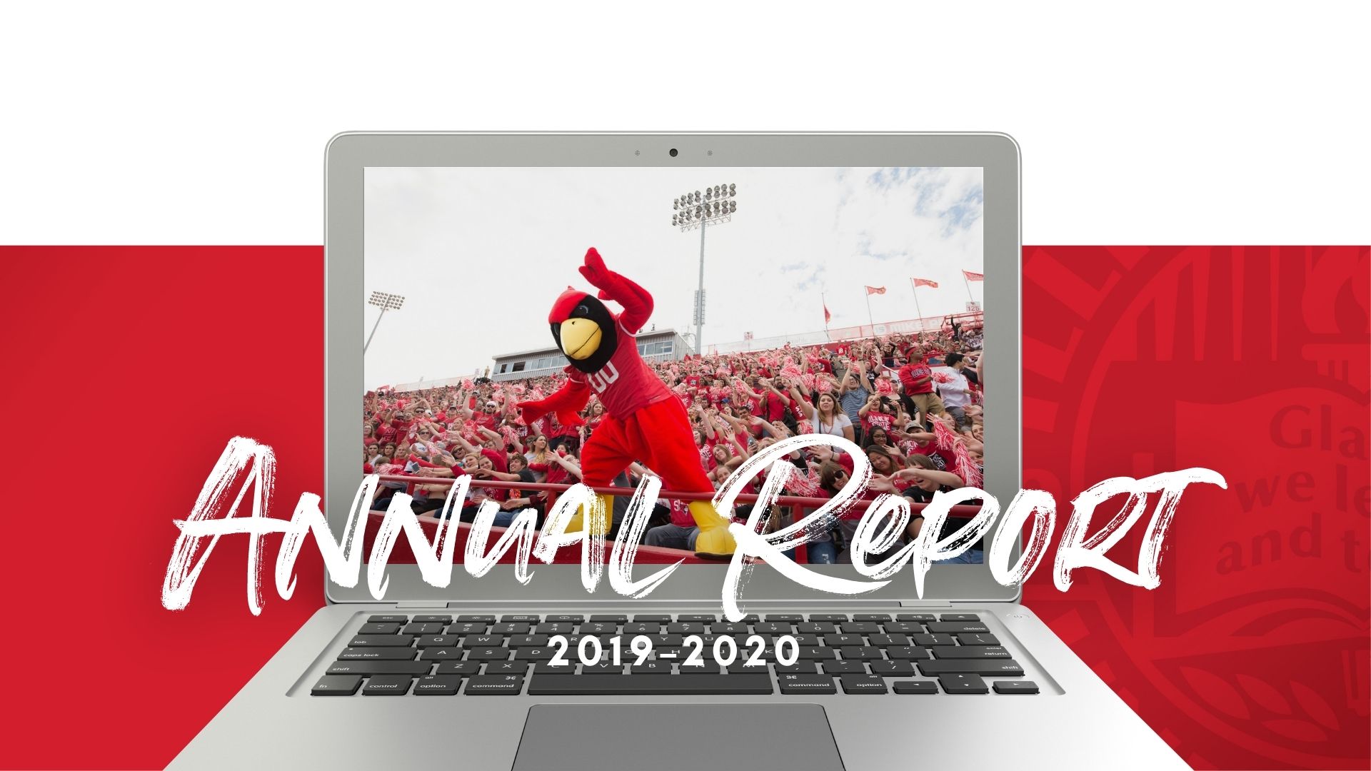 An open laptop with a image of Reggie Redbird posing with a football game crowd.