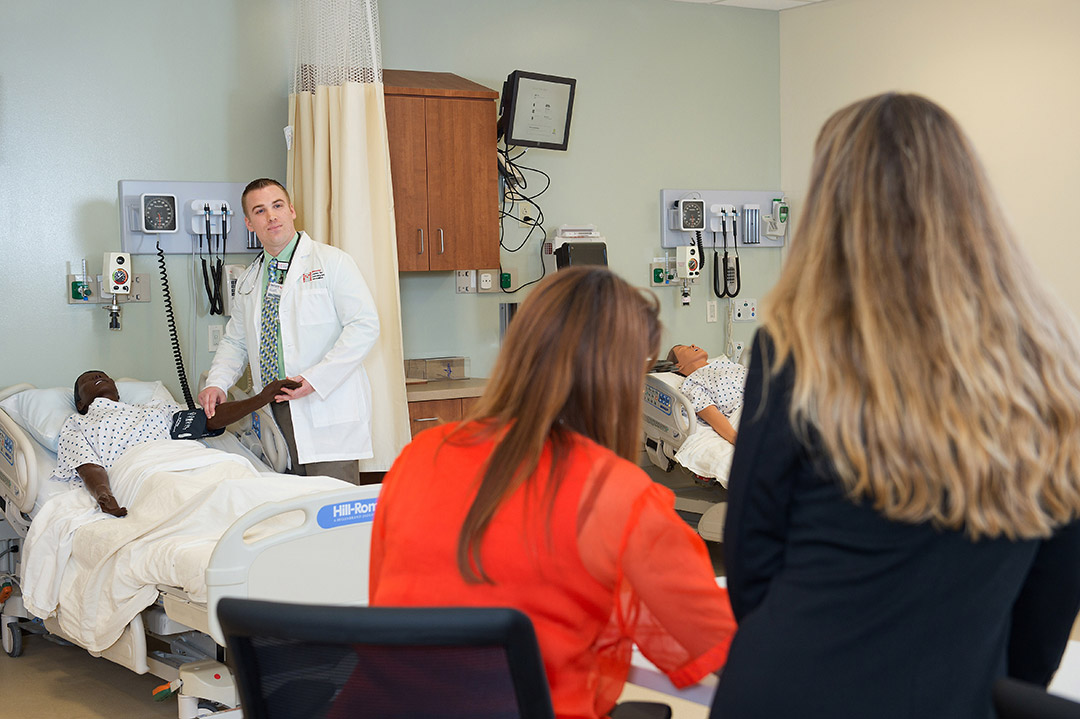 Students practicing on the health assessment lab