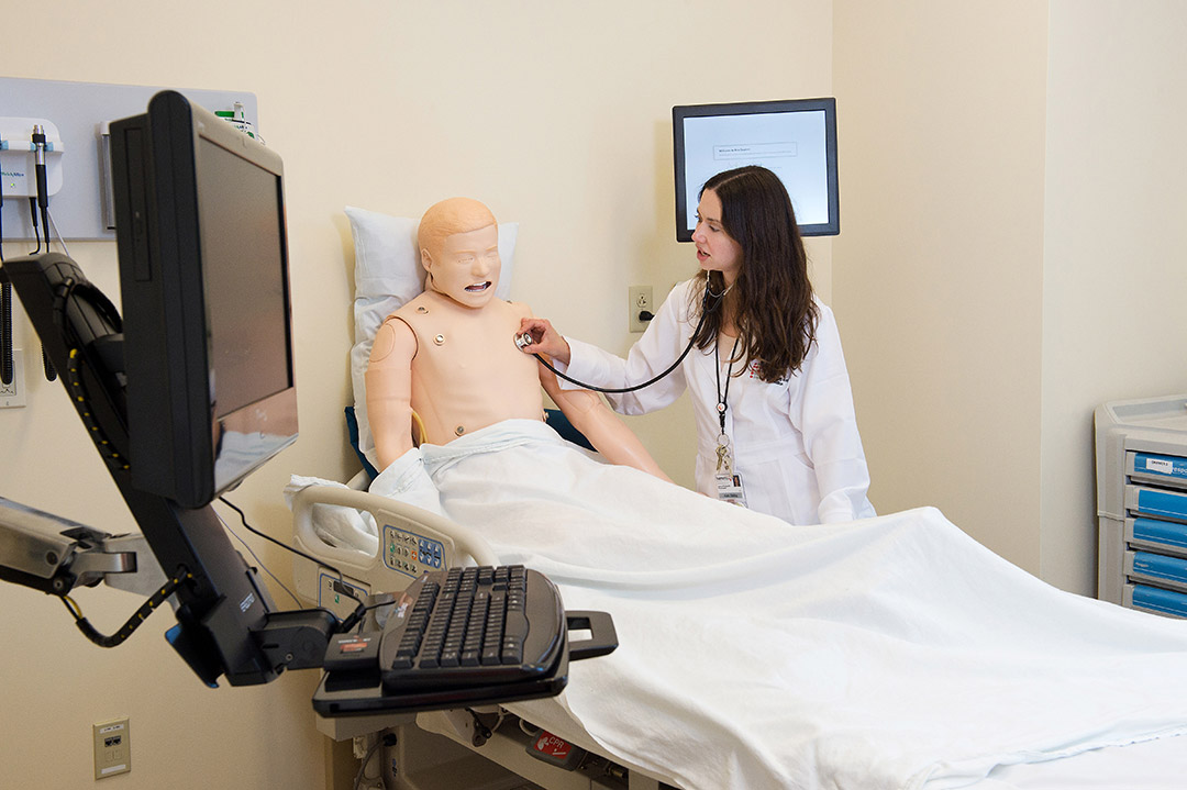 Student practicing hear the heart beat on the health assessment lab