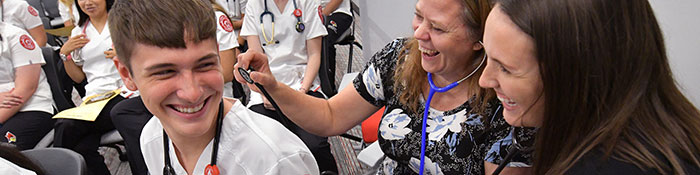 Students testing using the stethoscope on the Stethoscope Ceremony.