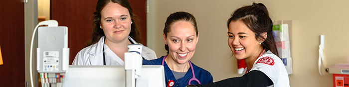 Students operating a machine.