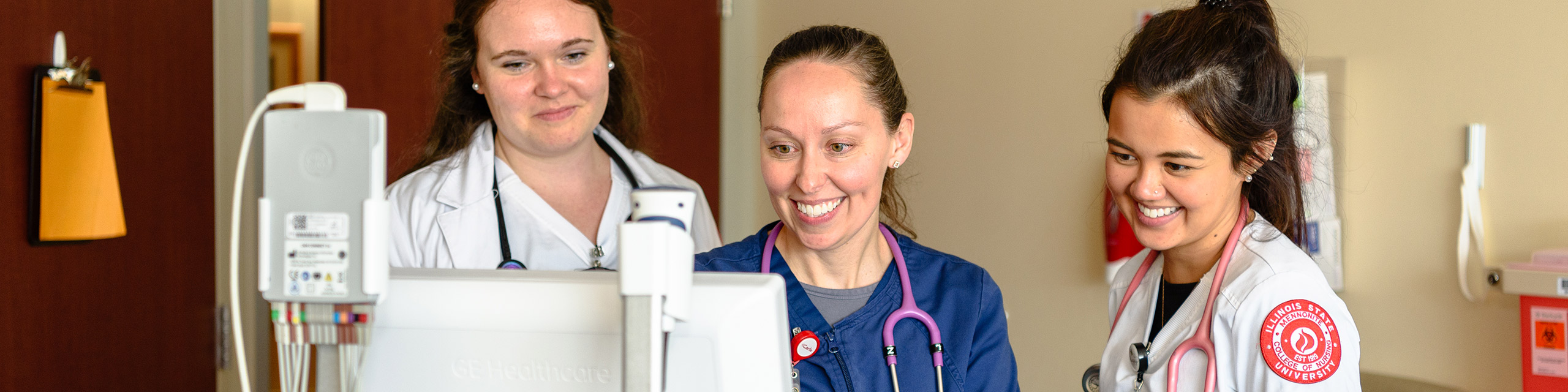 Three nurses looking to a monitor.