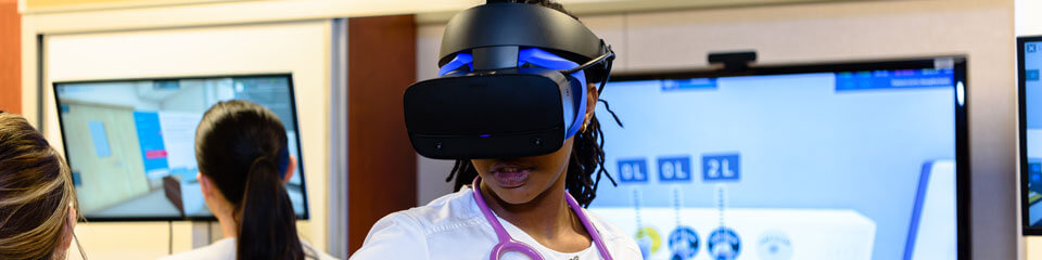 A student uses a virtual reality nursing simulator.