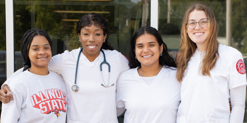 Four students pose for a photo.