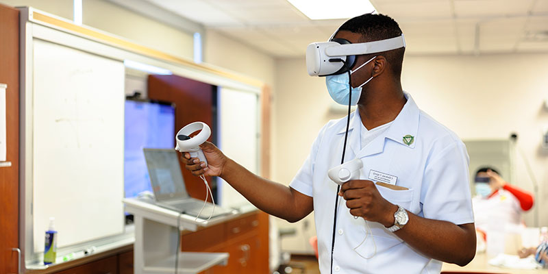 Student working with VR goggles in a lab.