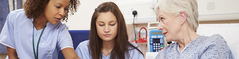 Two students practicing with patient