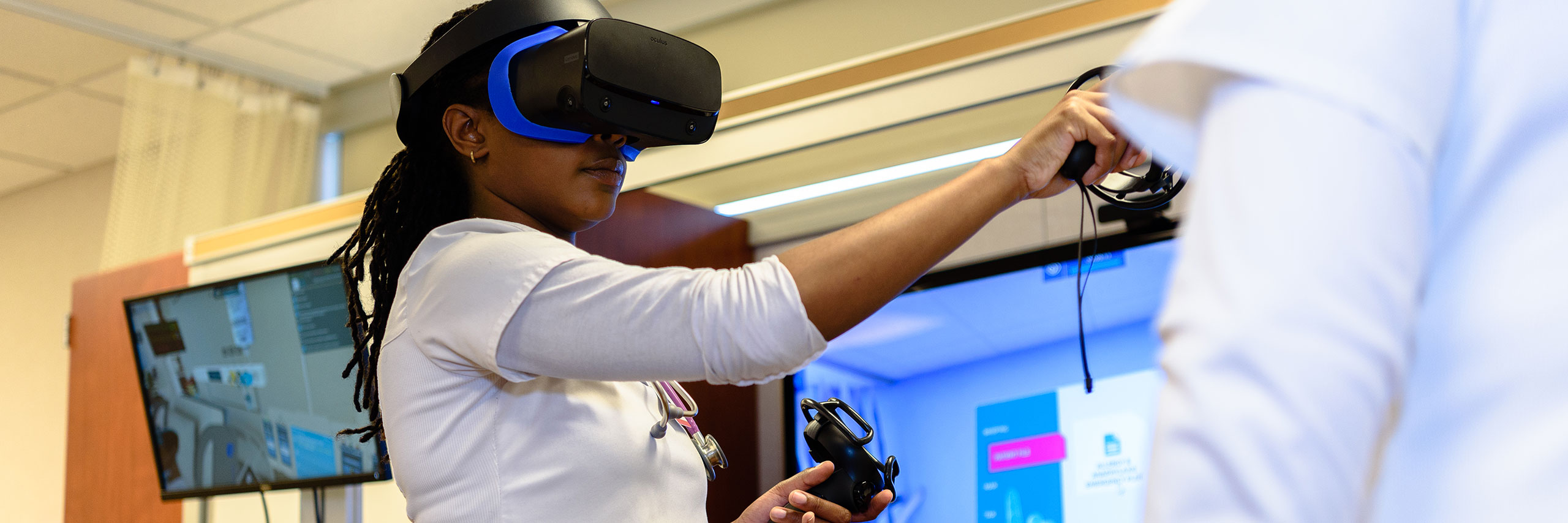 Student using VR goggles in a lab.