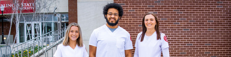 Three nursing students stand together for a photo.